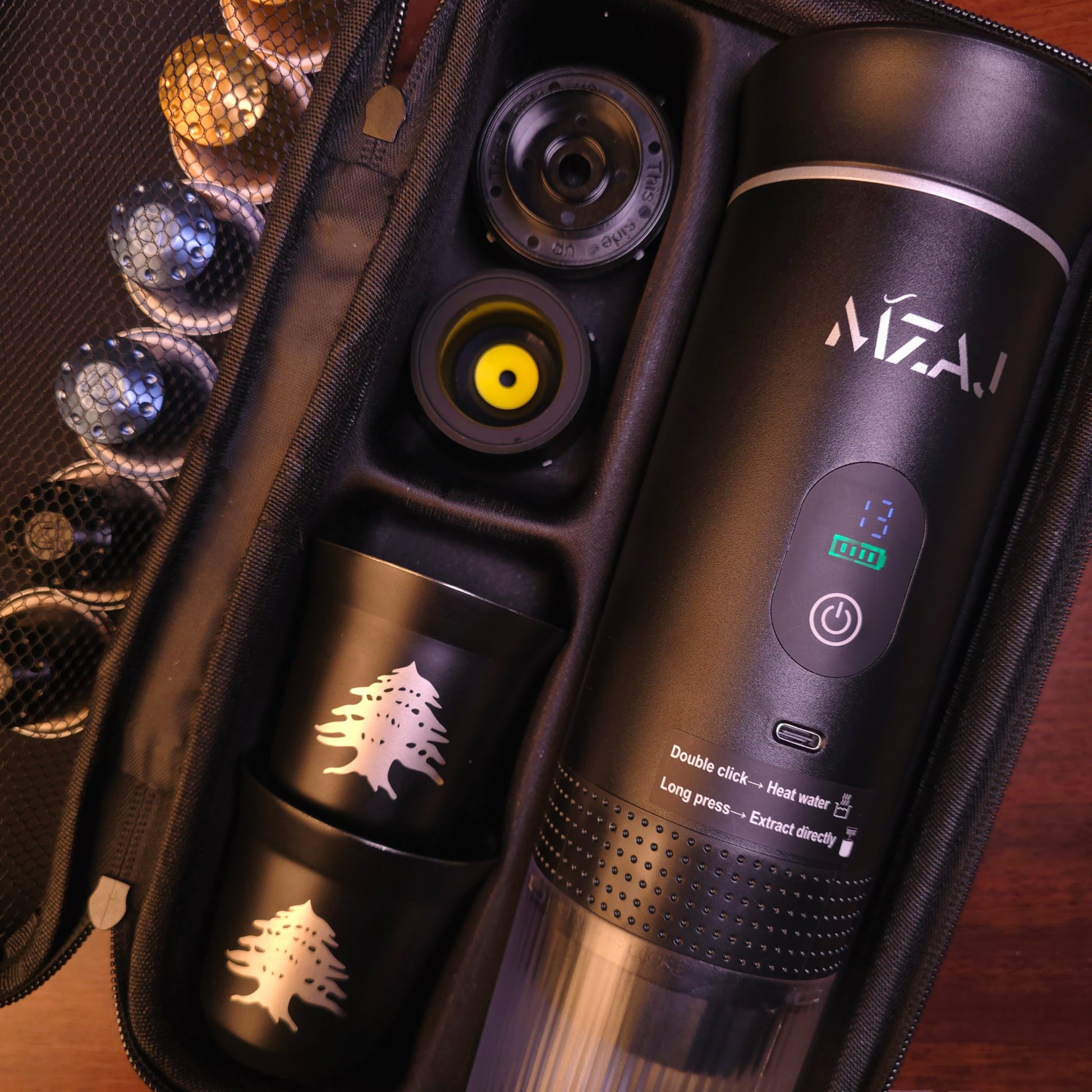 Black MZAJ COFFEE bottle with control panel and accessories in a case.