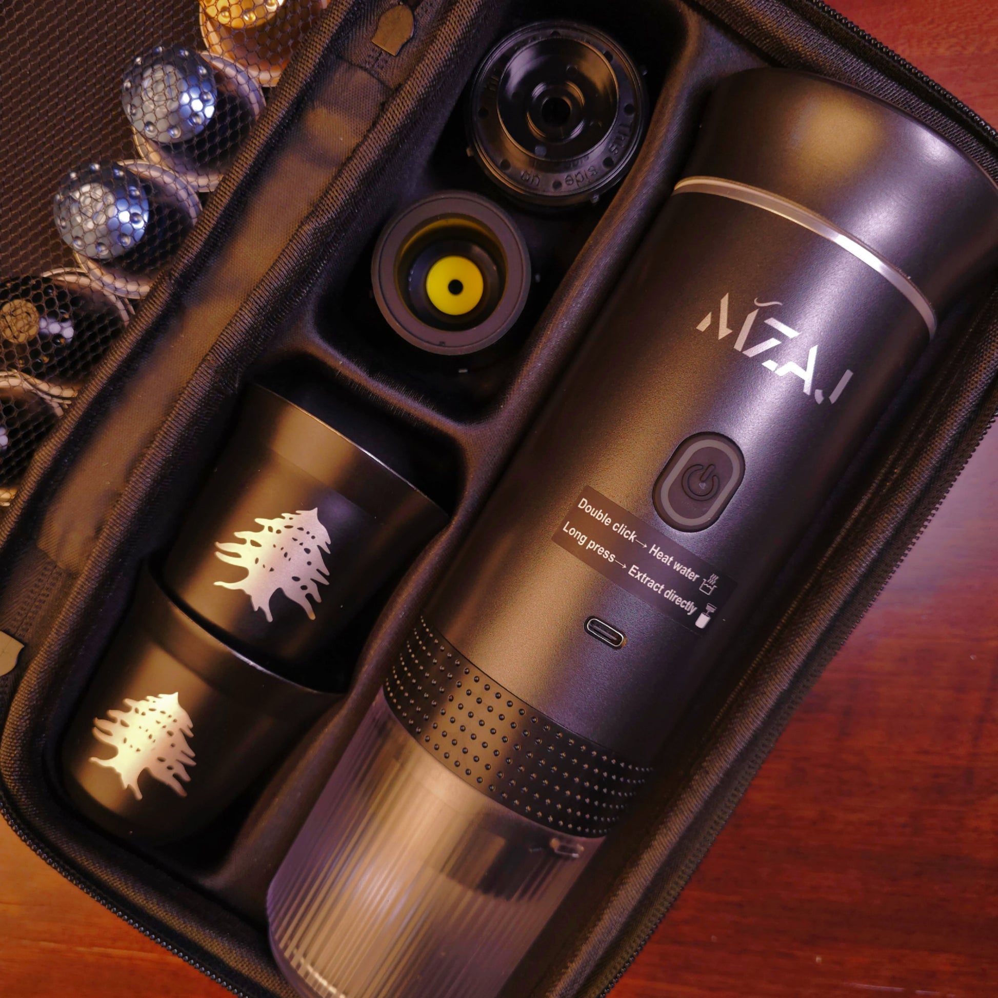 Mzaj coffee machine set with multiple cups and a carrying case on a wooden surface.