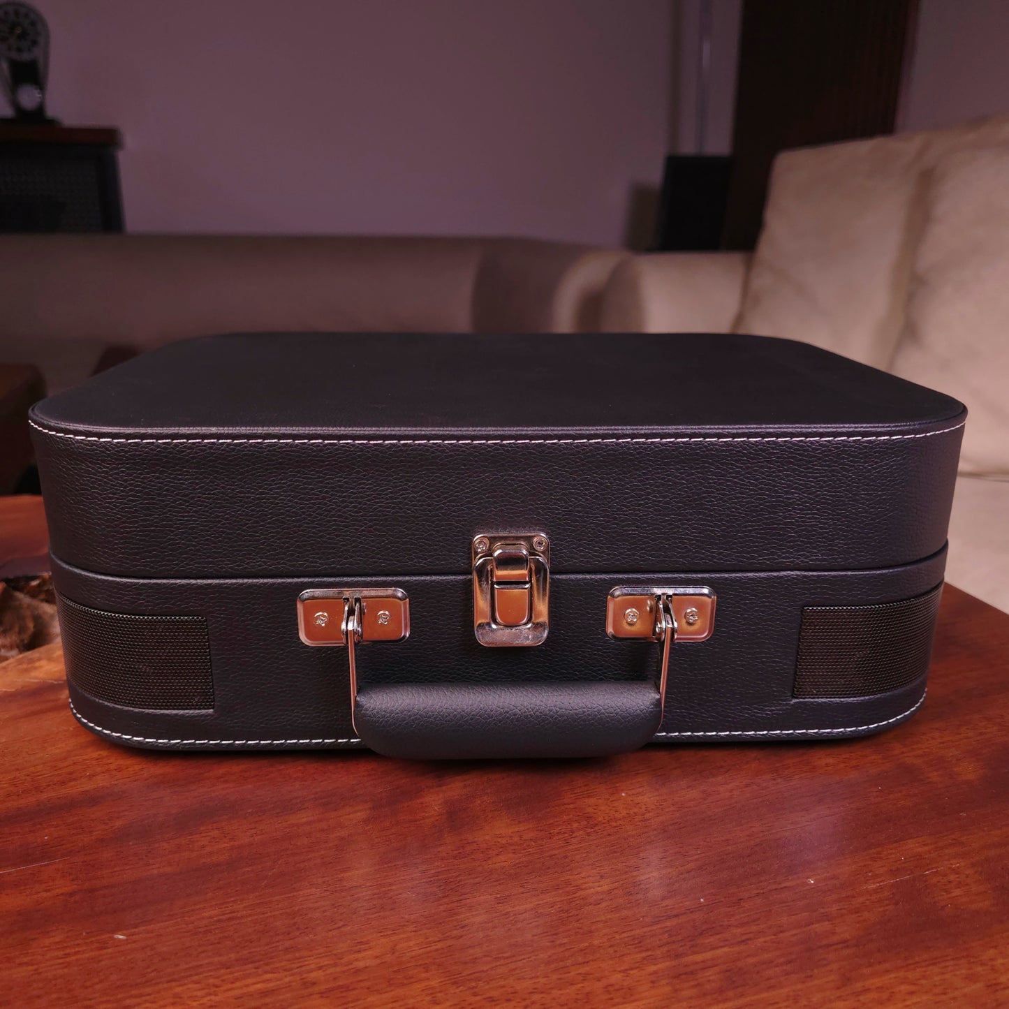 Black turntable mzaj case on a wooden table with a blurred background