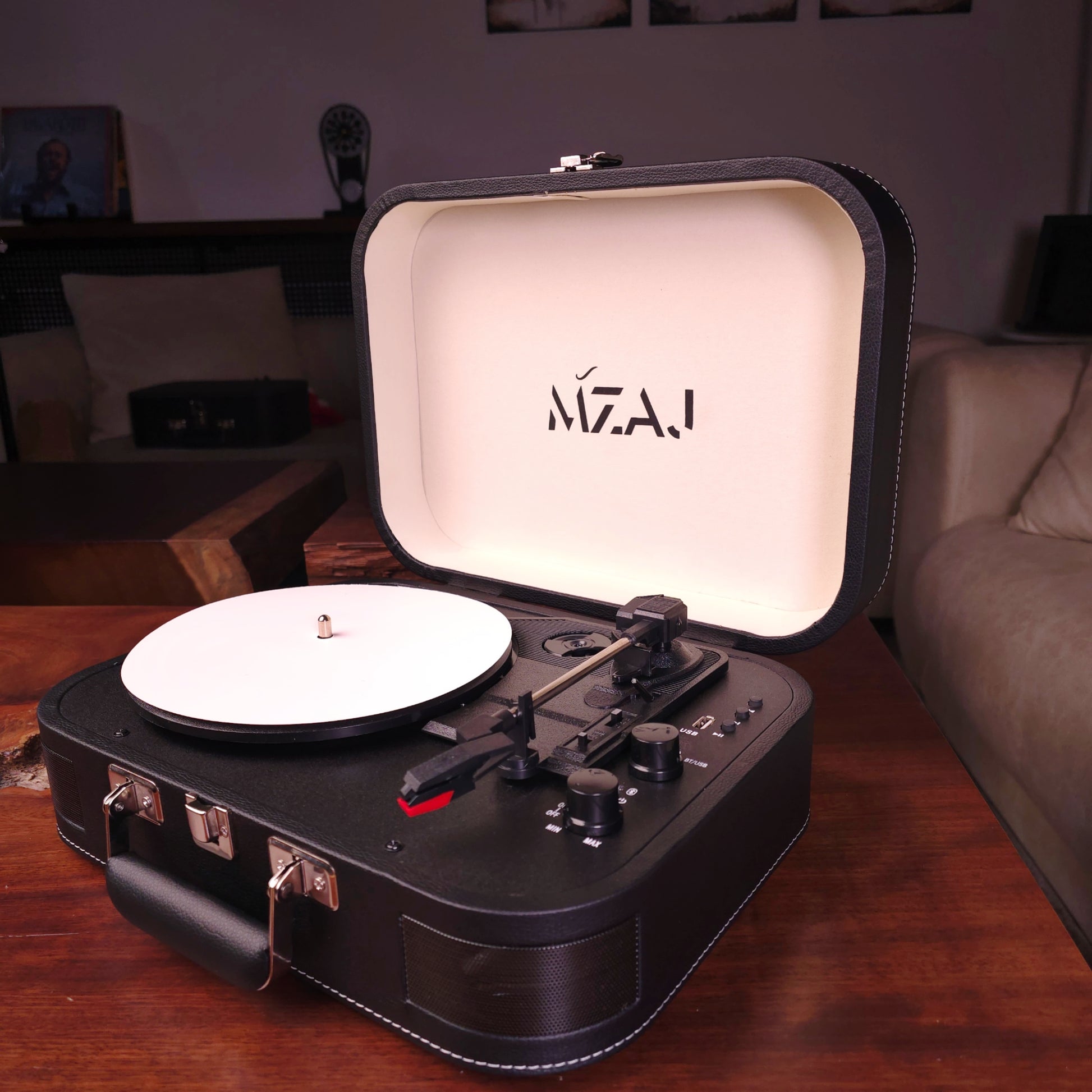 Portable record player with MZAJ branding on a wooden surface.