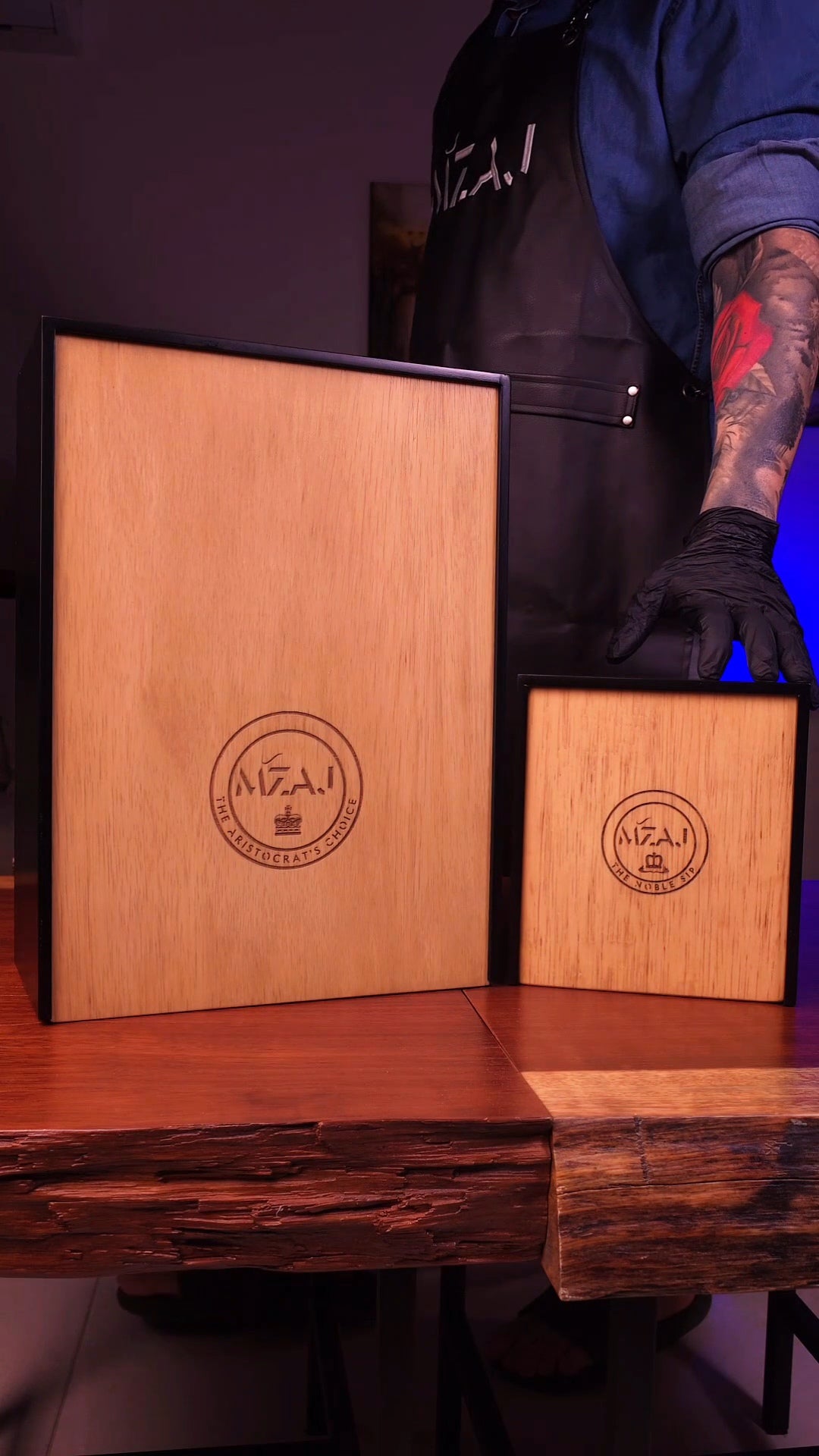 Wooden boxes with 'Mzaj' branding on a wooden surface.