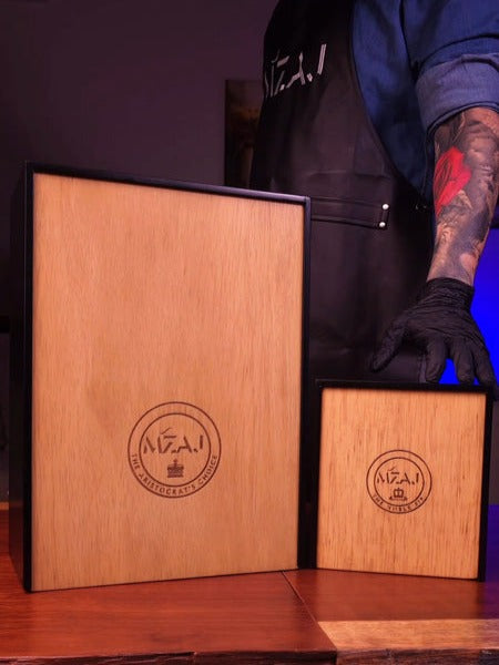 man with tattoo and two wooden boxes