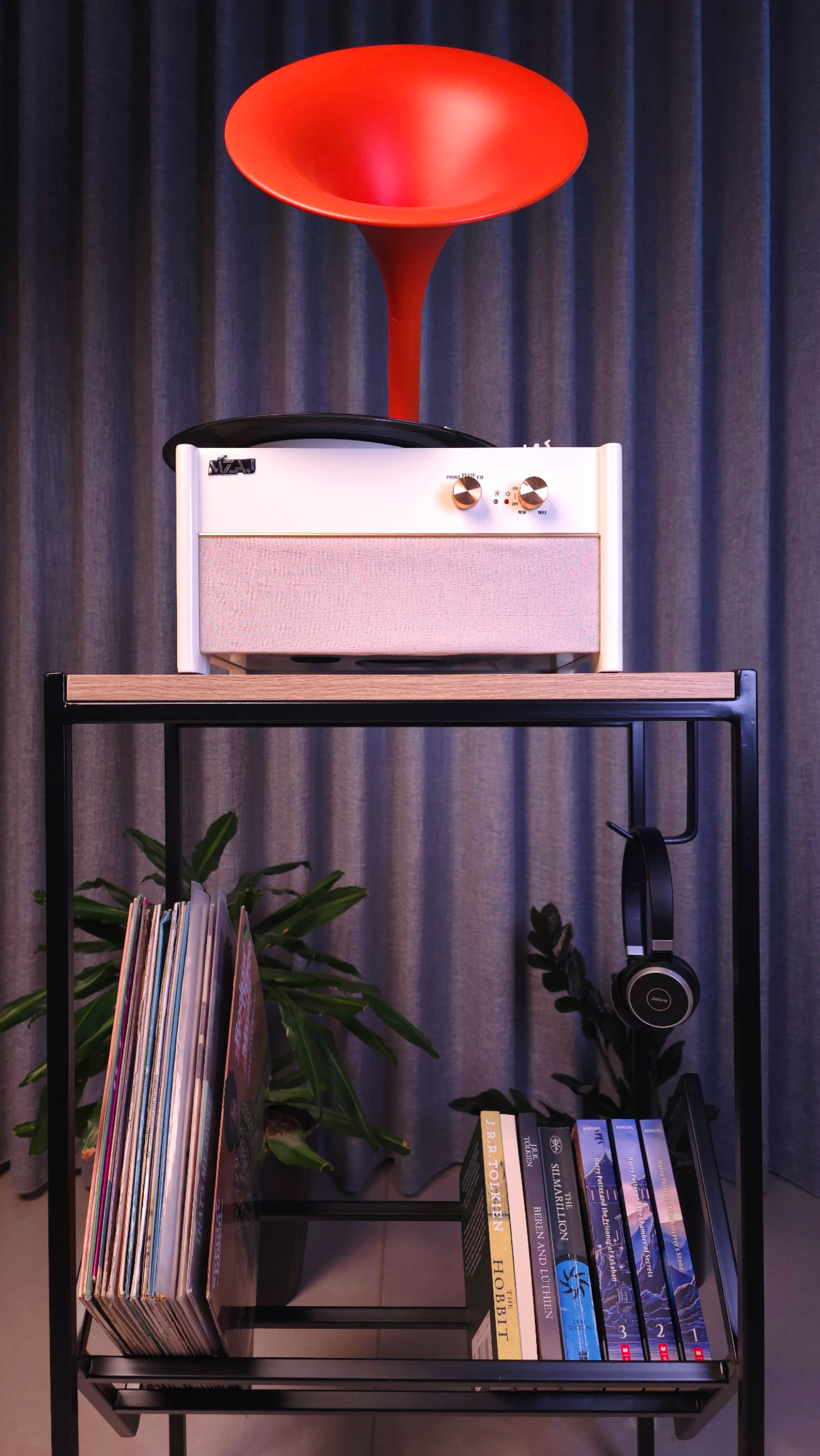 high table for turntable with vinyls and books, on top of it a retro turntable